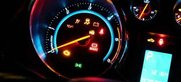 Illuminated dashboard warning lights on a vehicle instrument cluster